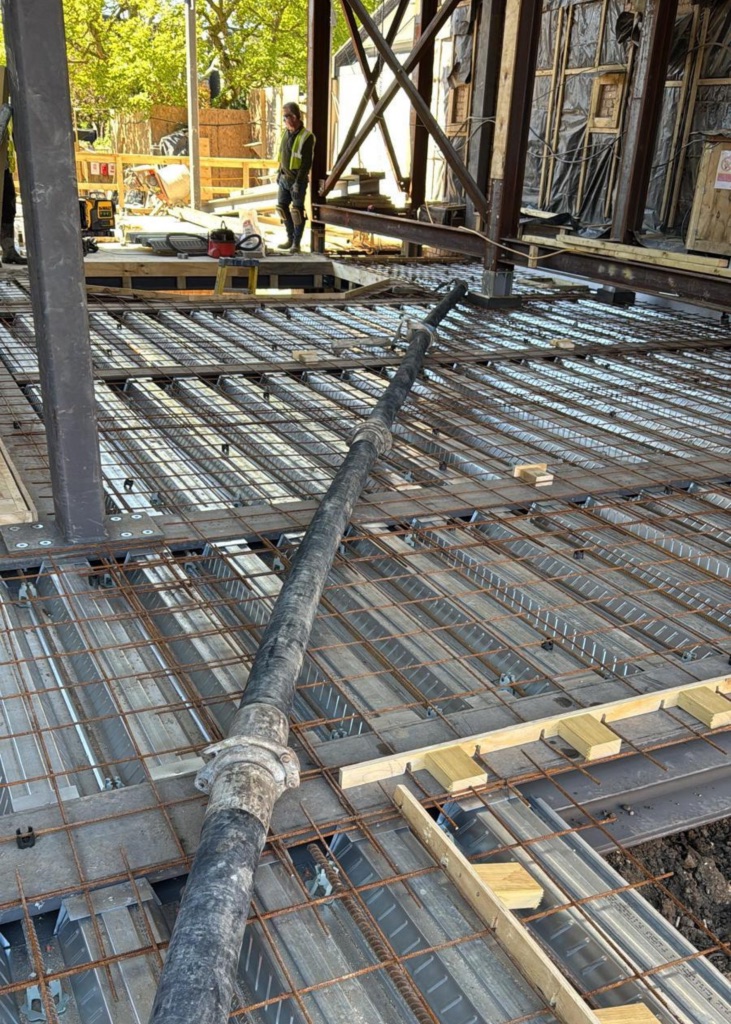 A King Concrete Pumping line pump feeding concrete on site near Mitcham